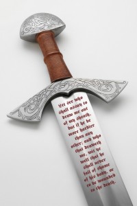 A sword with writing on it. Original photo by Flickr user Albion Europe ApS.